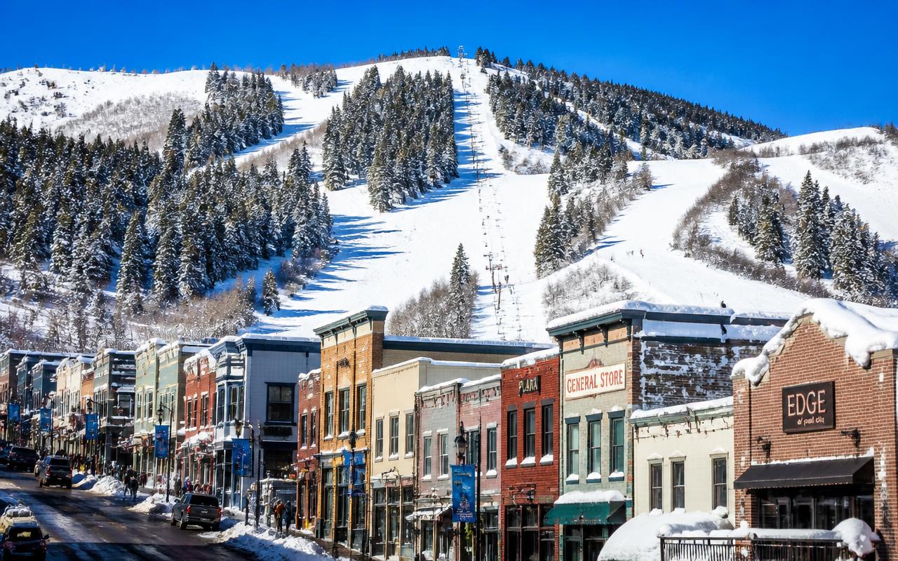 Historic Main Street in Park City, Utah with snow-covered ski runs rising behind the buildings